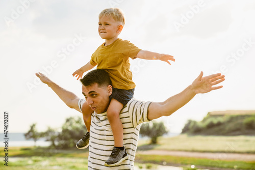 Young white father and son gesturing and playing together