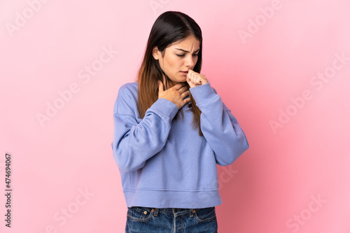 Young caucasian woman isolated on pink background coughing a lot