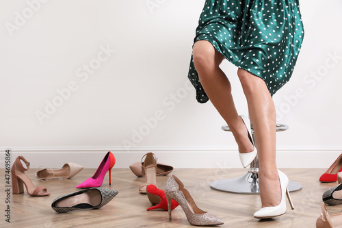 Woman trying on different shoes indoors, closeup