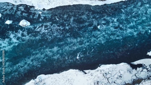 Wallpaper Mural Strong streams of cold blue water and melting ice from waterfall. Natural pattern ice water and foam in the north of Iceland. Torontodigital.ca
