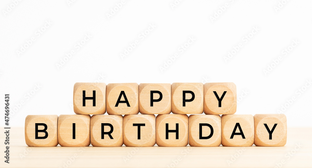 Happy Birthday phrase in wooden blocks on table. Copy space Happy Birthday phrase in wooden blocks on table. Copy space