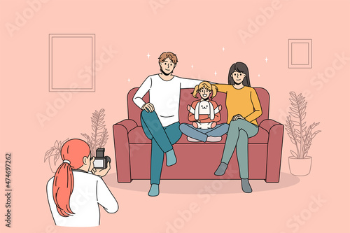 Family photosession and lifestyle concept. Woman photographer standing taking photo of young happy family with daughter sitting on coach smiling vector illustration 