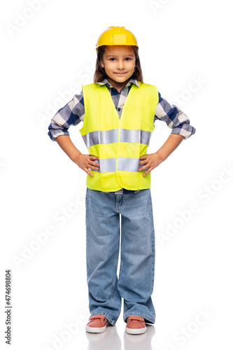 building, construction and profession concept - smiling little girl in protective helmet and safety vest over white background © Syda Productions