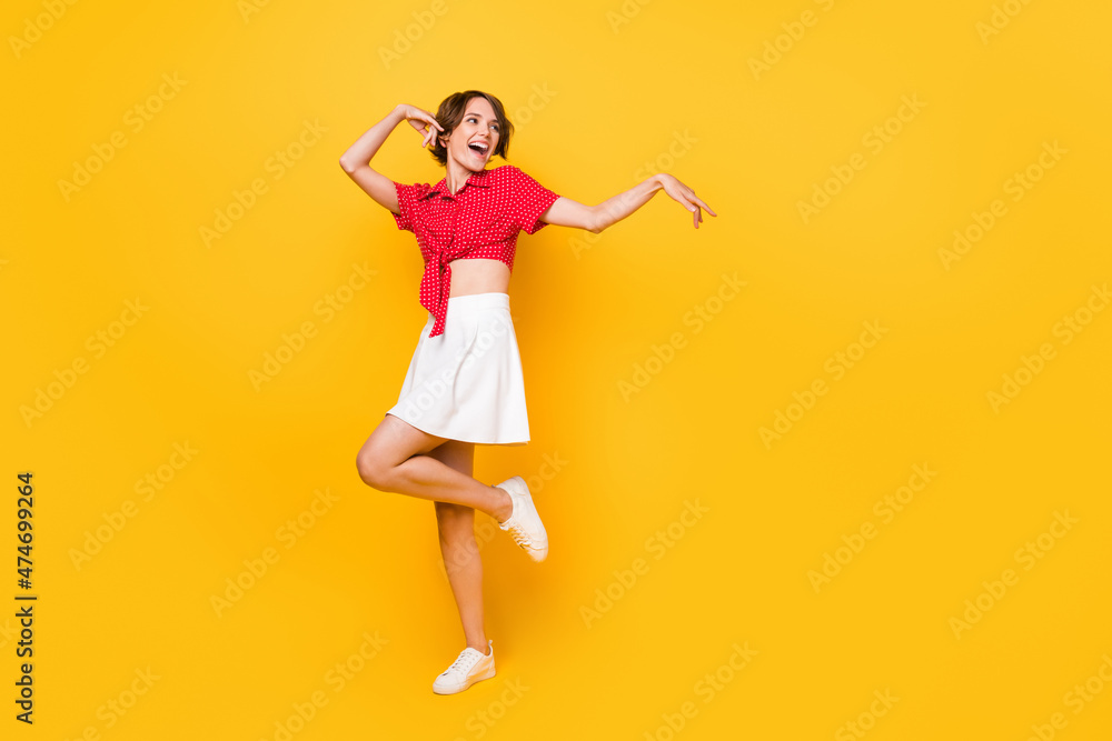 Full body photo of crazy excited person look empty space have good mood isolated on yellow color background Full body photo of crazy excited person look empty space have good mood isolated on yellow color background