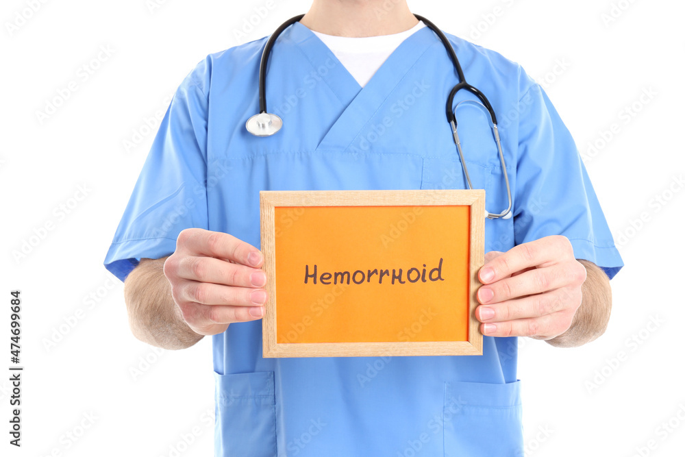 Nurse holds text Hemorrhoids, isolated on white background Nurse holds text Hemorrhoids, isolated on white background