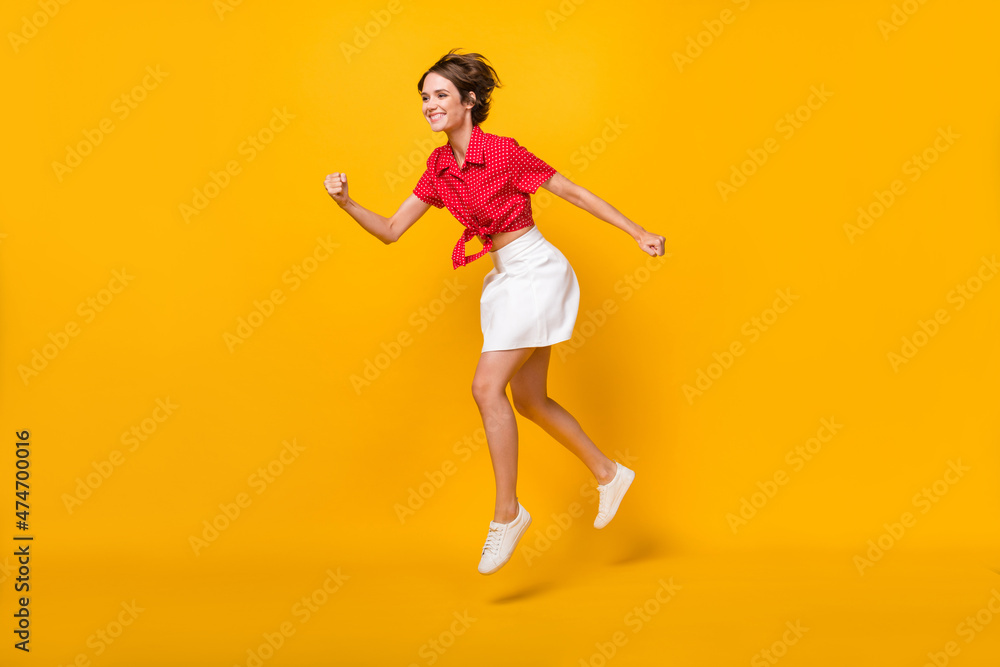 Full size profile photo of optimistic nice brunette lady run wear shirt skirt isolated on yellow background