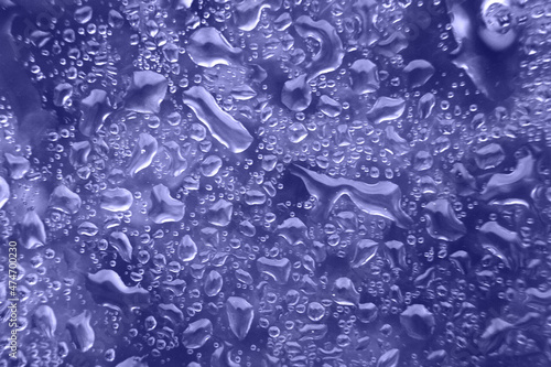 water drops on a purple background. Abstract background. Water drops on glass.