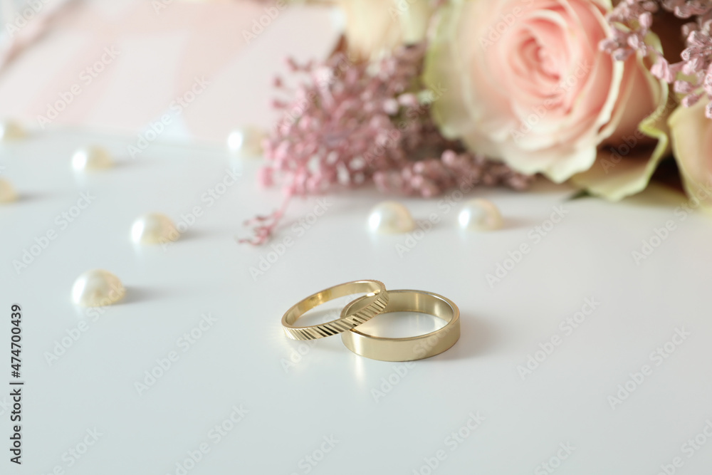 Concept of wedding accessories with wedding rings on white background Concept of wedding accessories with wedding rings on white background