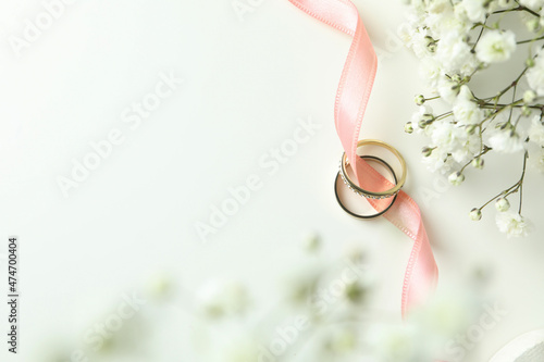 Concept of wedding accessories with wedding rings on white background