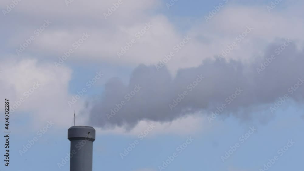 Smoke escapes from the chimney of the thermal power plant and dissipates into the blue sky. Environmental pollution. Industrial landscape. Daegu Smoke escapes from the chimney of the thermal power plant and dissipates into the blue sky. Environmental pollution. Industrial landscape. Daegu