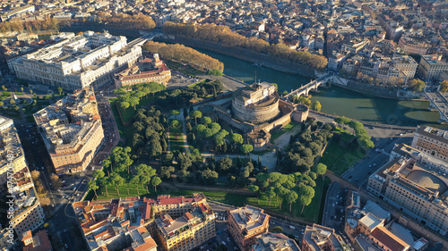 Aerial drone view of iconic Castel Sant'Angelo (castle of Holy Angel) and Ponte or bridge Sant'Angelo with statues in river of Tiber next to famous Vatican, Rome, Italy photo