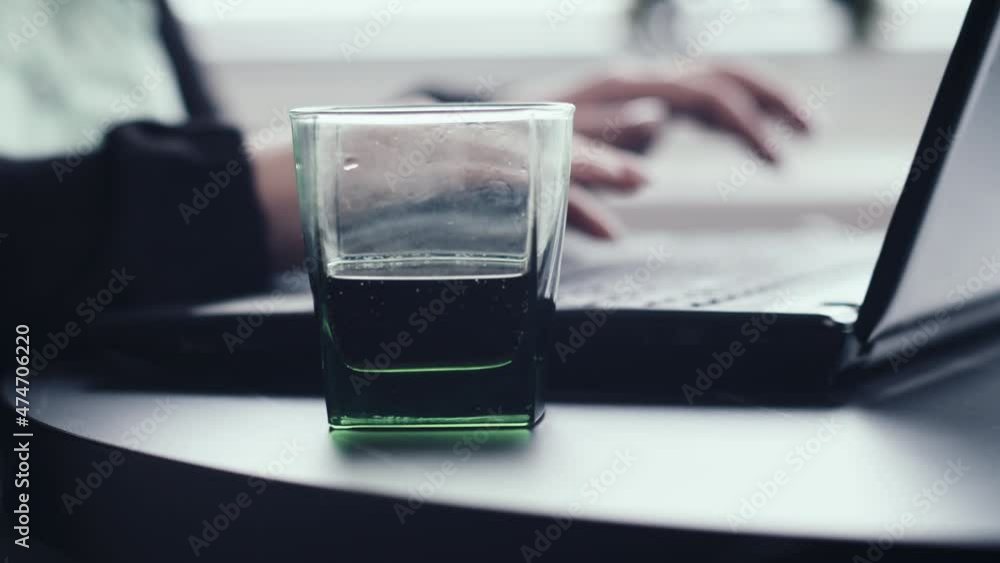 woman working on laptop at home close up, freelance, a glass of soda near the laptop, cinematic shot woman working on laptop at home close up, freelance, a glass of soda near the laptop, cinematic shot