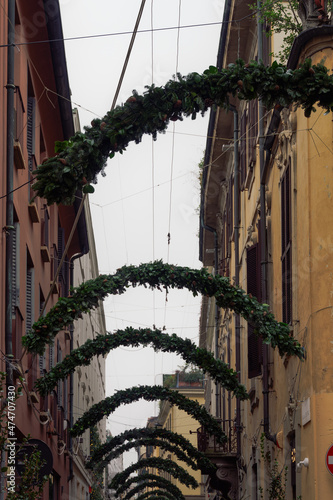 Milan, Italy Christmas hanging decorations above stores and houses. Exterior day view of festive road display at Montenapoleone area. photo