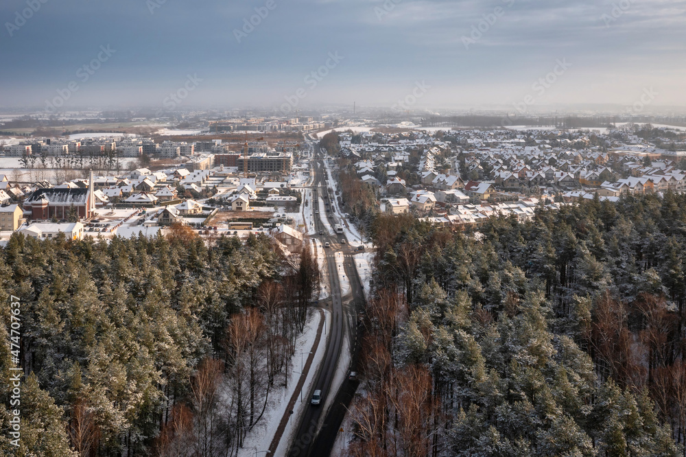 Aerial landscape of the road through snowy forest at winter, Poland.