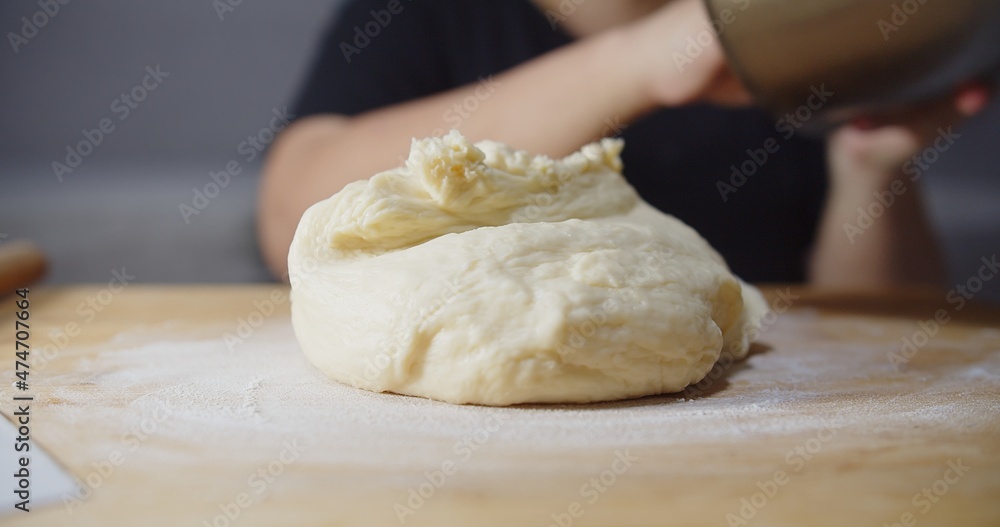 Close up fluffy dough on wooden board, preparing kneading dough bread bakery at home kitchen
Close up fluffy dough on wooden board, preparing kneading dough bread bakery at home kitchen