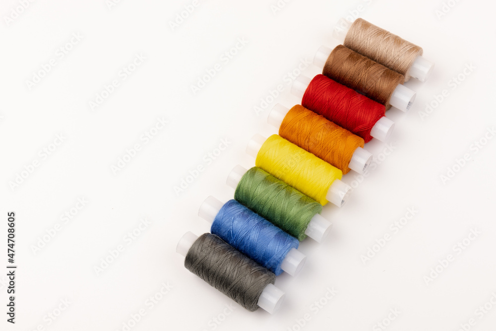 Color sewing threads isolated on white background. Different colors.Bright bobbin thread. Color sewing threads isolated on white background. Different colors.Bright bobbin thread.