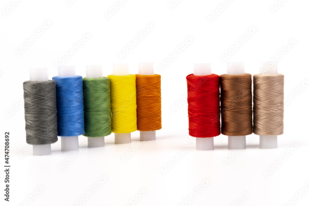 Color sewing threads isolated on white background. Different colors.Bright bobbin thread. Color sewing threads isolated on white background. Different colors.Bright bobbin thread.