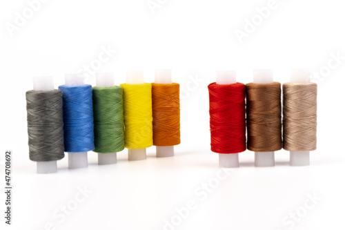 Color sewing threads isolated on white background. Different colors.Bright bobbin thread.