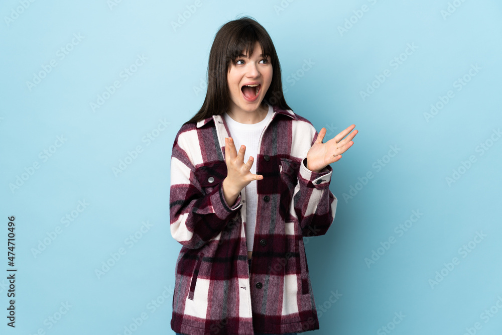 Teenager Ukrainian girl isolated on blue background with surprise facial expression Teenager Ukrainian girl isolated on blue background with surprise facial expression