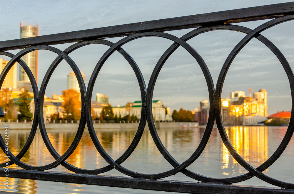 Metal fence on the river bank . Metal fence on the river bank .