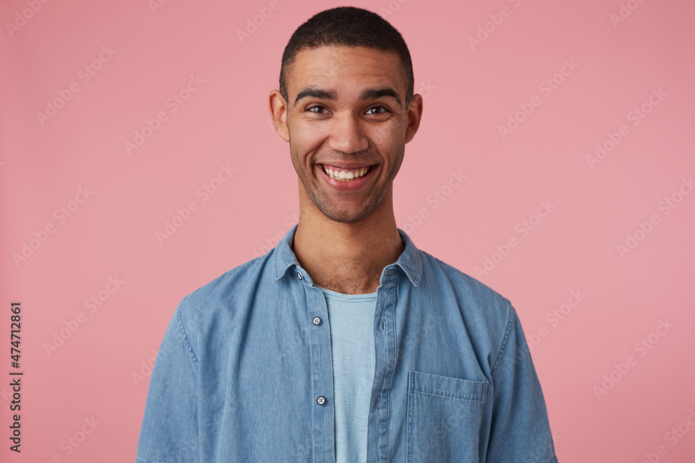 studio portrait of middle age middle eastern man wears blue shirt smiles broadly and feels happy. isolated over pink background studio portrait of middle age middle eastern man wears blue shirt smiles broadly and feels happy. isolated over pink background