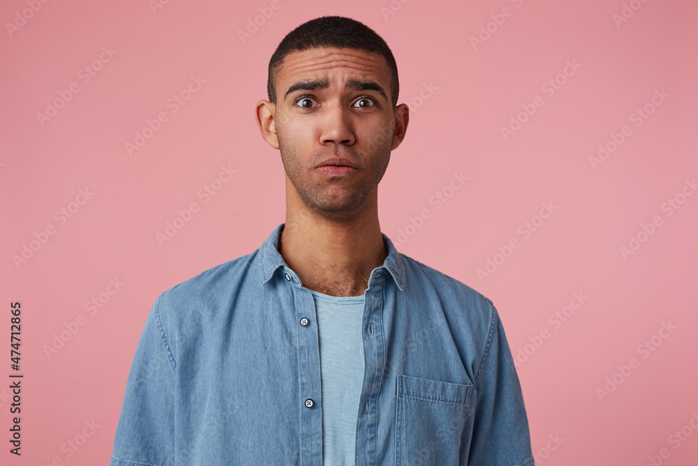 studio portrait of middle age middle eastern man wears blue shirt feels guilty, shocked with negative facial expression, isolated over pink background studio portrait of middle age middle eastern man wears blue shirt feels guilty, shocked with negative facial expression, isolated over pink background