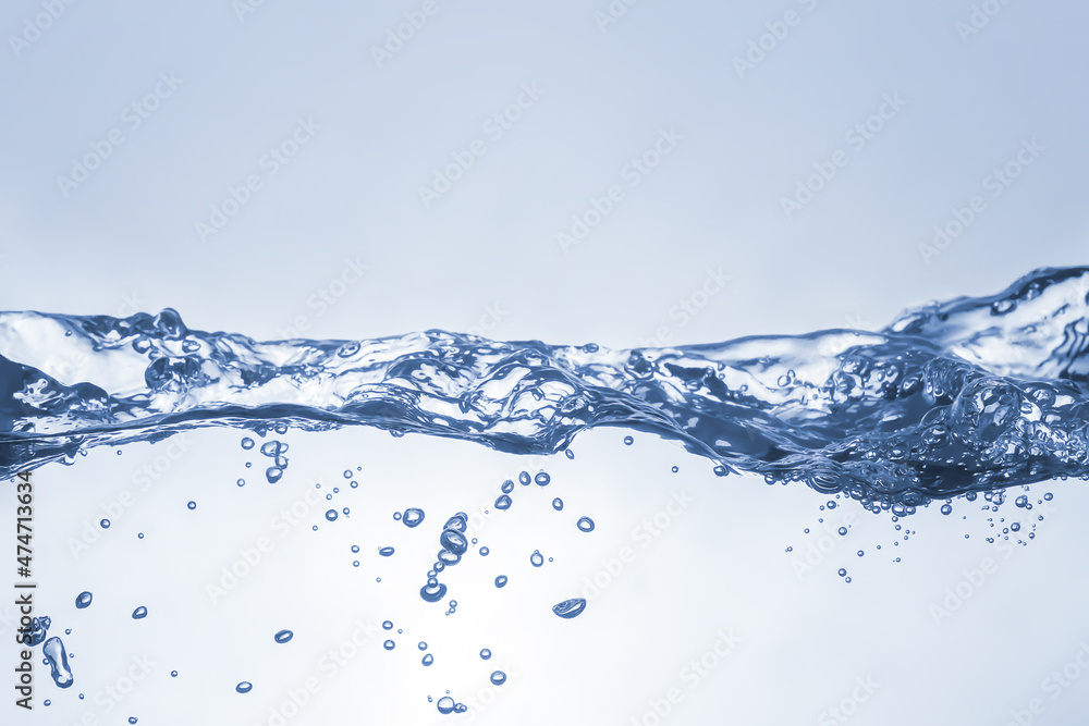Water splash on blue background. Aqua flowing in waves and creating bubbles. Drops on the water surface feel fresh and clean. Water splash on blue background. Aqua flowing in waves and creating bubbles. Drops on the water surface feel fresh and clean.