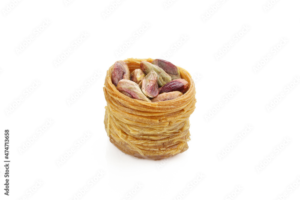 Pistachios in kadayif shaped like bird nest. Turkish delicacy isolated on white background Pistachios in kadayif shaped like bird nest. Turkish delicacy isolated on white background