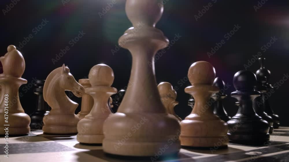rotating chessboard with combination of whte and black wooden chess figures ready to play with bright lens flare and wide angle lens. 360 degree rotation. High quality 4k footage rotating chessboard with combination of whte and black wooden chess figures ready to play with bright lens flare and wide angle lens. 360 degree rotation. High quality 4k footage