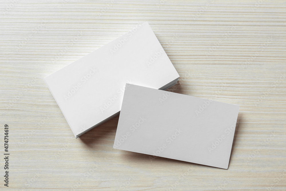 Blank business cards on white wooden table, flat lay. Mockup for design Blank business cards on white wooden table, flat lay. Mockup for design
