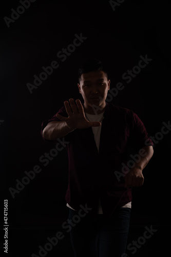 man dancing to music alone in the dark