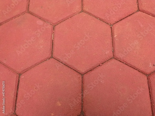 red hexagon-shaped paving neatly installed in the yard