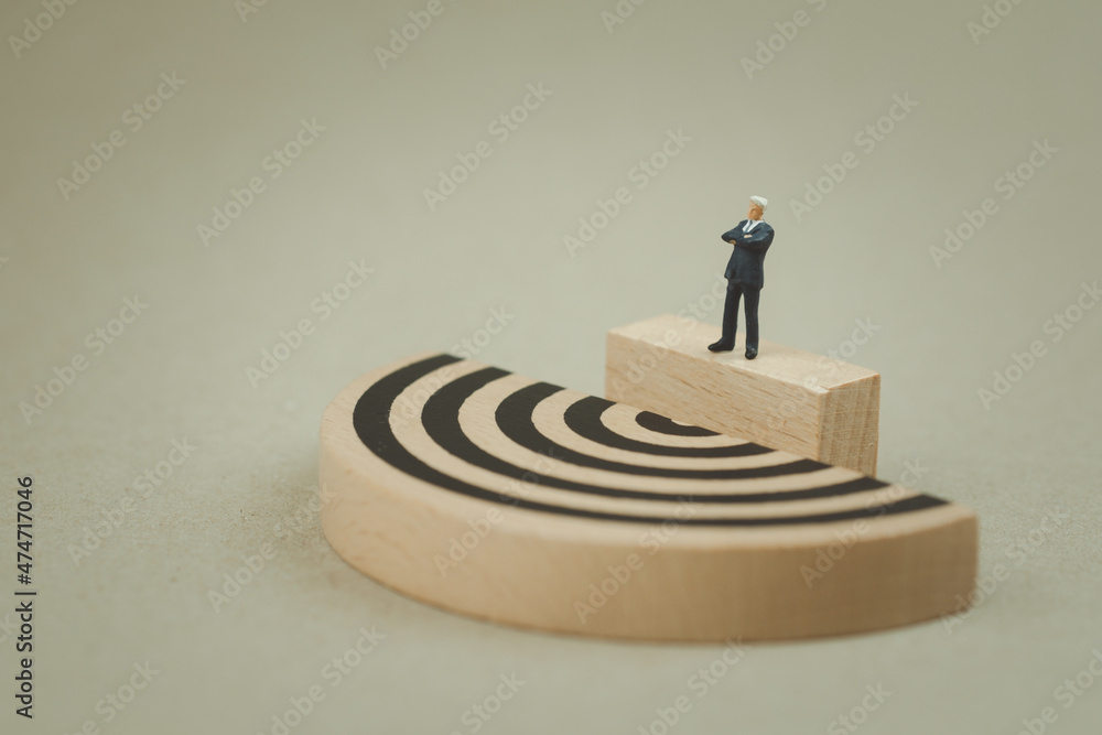Miniature businessman standing and see maze Miniature businessman standing and see maze
