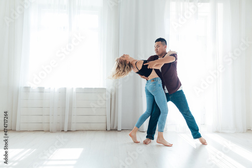 woman and man dancing to bachata music photo