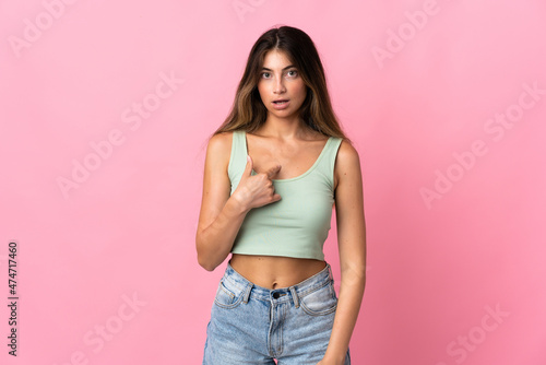 Young caucasian woman isolated on pink background pointing to oneself
