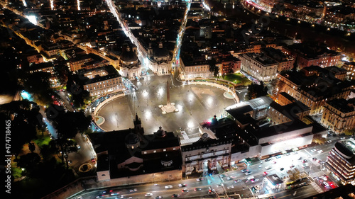 Fototapeta Naklejka Na Ścianę i Meble -  Aerial drone night shot from iconic illuminated Piazza del Popolo or People's square, an elliptical popular landmark square centered by Rome's oldest obelisk , Rome histroric centre, Italy