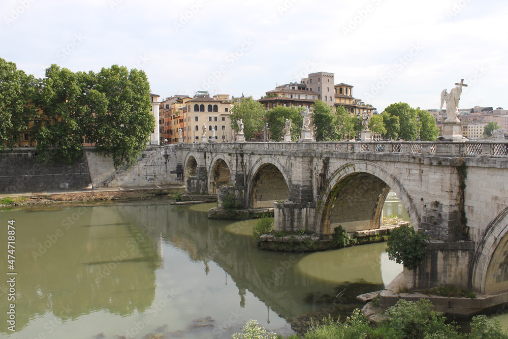 Bridge over the Tiber river with marble sculptures in downtown Rome, Italy