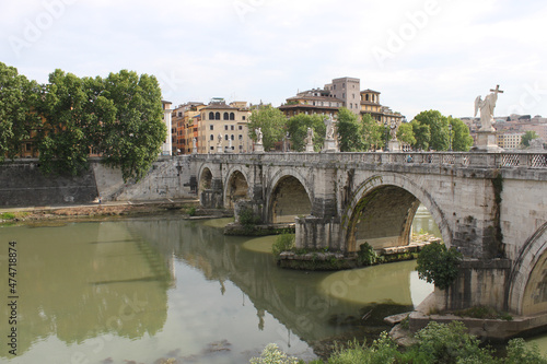 Bridge over the Tiber river with marble sculptures in downtown Rome, Italy