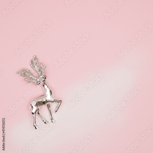 Santa reindeer on snow and pastel pink bacground. Winter holiday concept. New Year background. © lagano