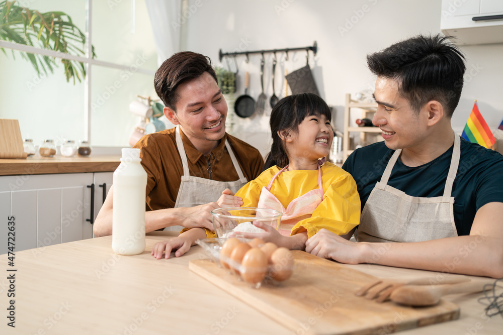 Asian attractive LGBTQ gay family teach girl kid making yeast dough. Asian attractive LGBTQ gay family teach girl kid making yeast dough.