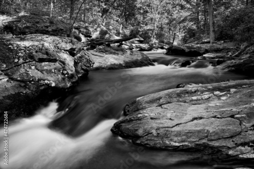 Black and White photograph of cliffs along Deer Creek in Harford County Maryland with rushing water and springtime water flow