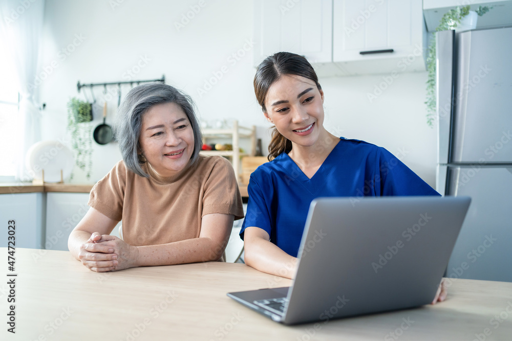 Asian nurse at nursing home take care of disabled senior elderly woman Asian nurse at nursing home take care of disabled senior elderly woman