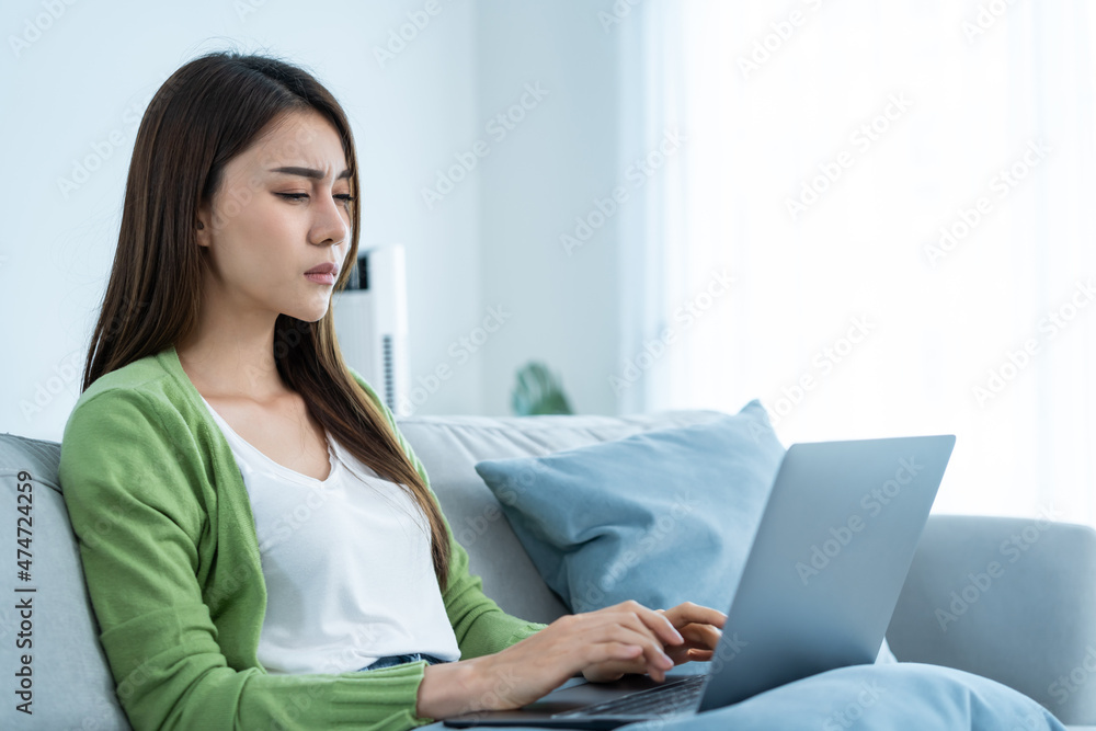 Exhausted Asian business woman hurt eye while using laptop computer. Exhausted Asian business woman hurt eye while using laptop computer.