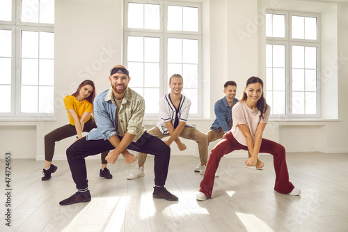 Group of happy, smiling young people having a dancing class. Cheerful, talented, beautiful, well-trained dancers in casual wear all together practising a new choreo in their light, sunny dance studio © Studio Romantic
