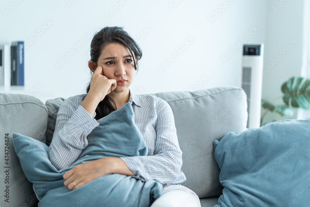 Asian beautiful unhappy woman sit on sofa feel frustrated and stressed Asian beautiful unhappy woman sit on sofa feel frustrated and stressed