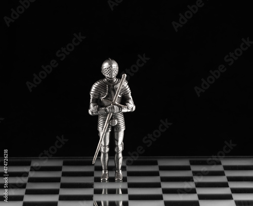 iron knight chess king on a chessboard photo
