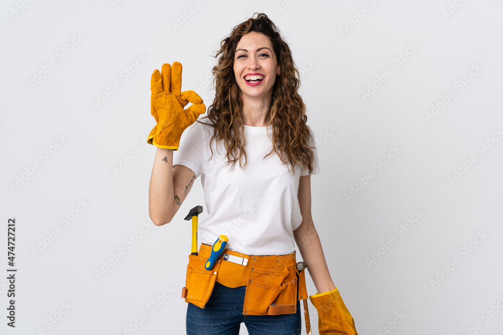 Young electrician man isolated on white background showing ok sign with fingers Young electrician man isolated on white background showing ok sign with fingers