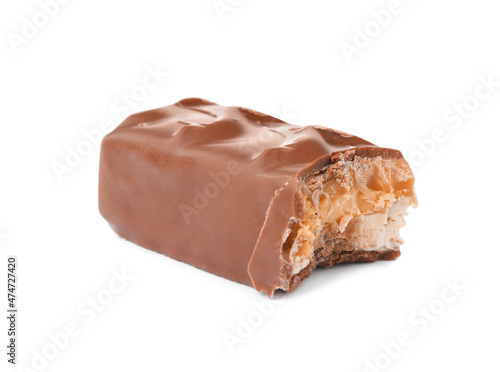 Piece of chocolate bar with caramel, nuts and nougat isolated on white