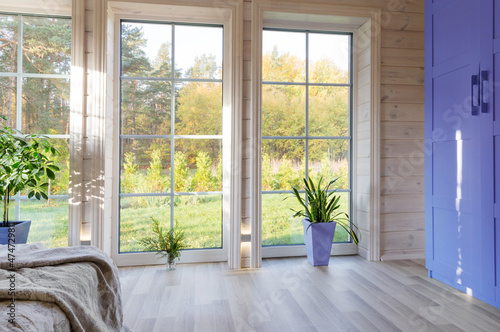 Bright interior, room in wooden house with large window. Scandinavian style.