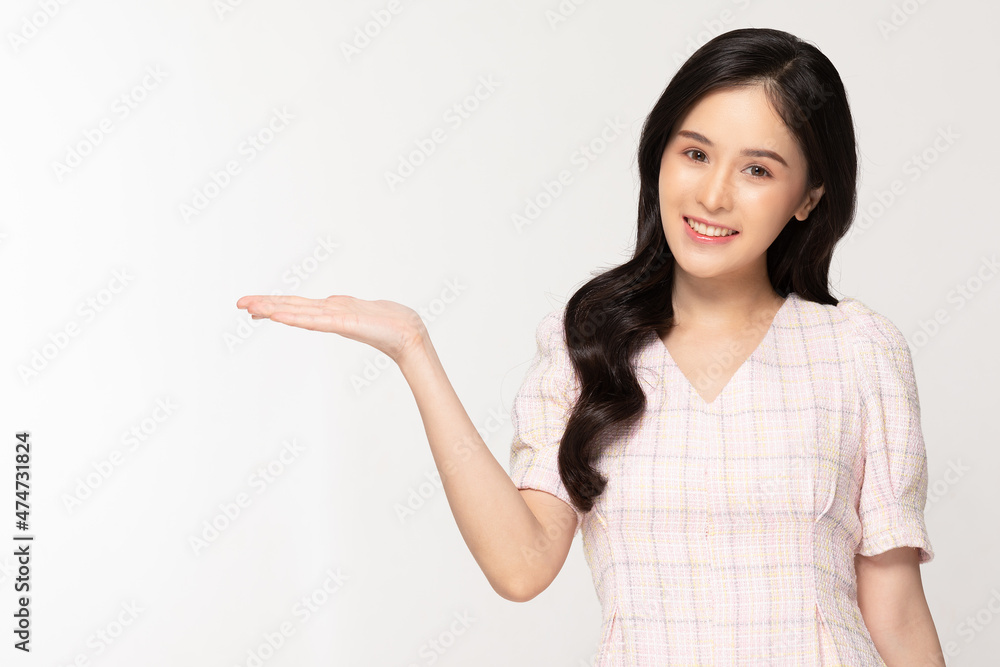 Happy attractive asian young woman smile and open hand palm to copy space isolated on white background.Cheerful pretty girl wear casual dress open palm to empty space for mockup to display product Happy attractive asian young woman smile and open hand palm to copy space isolated on white background.Cheerful pretty girl wear casual dress open palm to empty space for mockup to display product